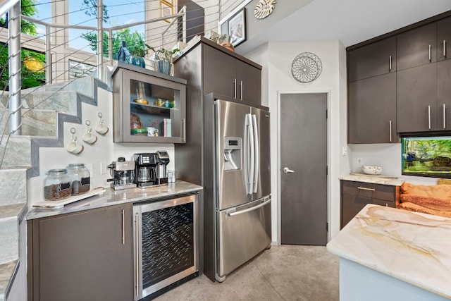 kitchen with dark brown cabinetry, stainless steel fridge with ice dispenser, and beverage cooler