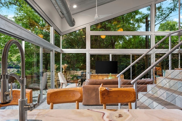 sunroom / solarium featuring a wealth of natural light and ceiling fan