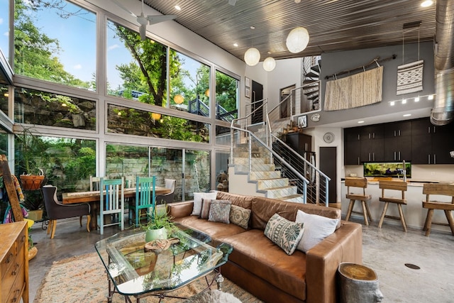 living room featuring wood ceiling and a high ceiling