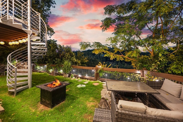 yard at dusk featuring a fire pit