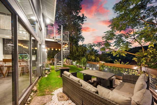 patio terrace at dusk featuring an outdoor hangout area