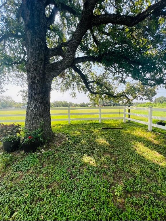 view of yard featuring a rural view and fence