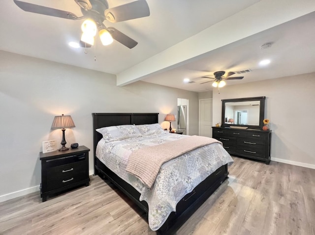 bedroom featuring ceiling fan, beam ceiling, and light wood-type flooring