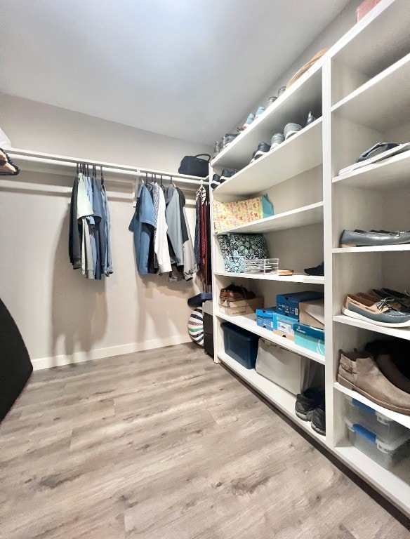 spacious closet with light hardwood / wood-style floors