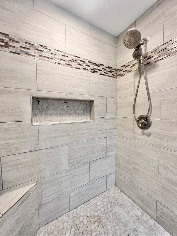 bathroom with tiled shower