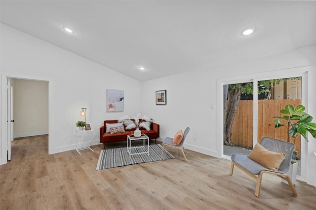 sitting room featuring light wood-type flooring and lofted ceiling