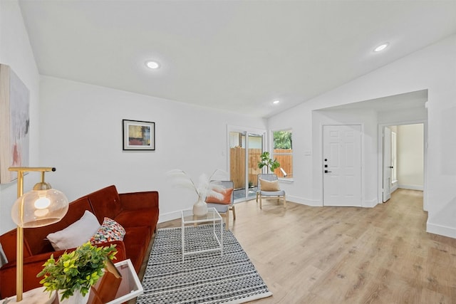 living room featuring light hardwood / wood-style flooring and lofted ceiling