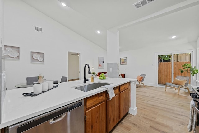 kitchen with stainless steel dishwasher, sink, light wood-type flooring, and high vaulted ceiling