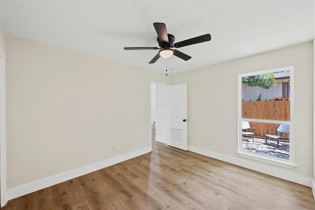 spare room with light hardwood / wood-style floors and ceiling fan