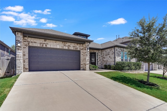 view of front facade with a front yard and a garage