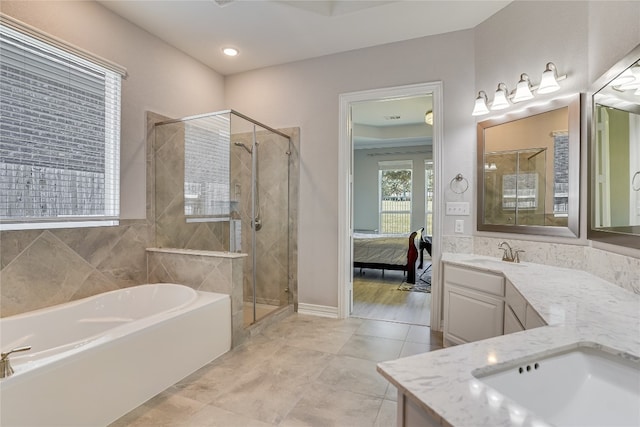 bathroom featuring tile patterned floors, independent shower and bath, and vanity