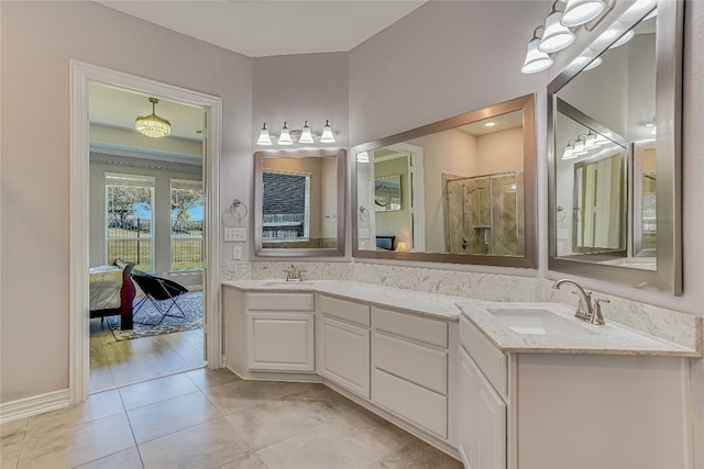 bathroom featuring double sink vanity, walk in shower, and tile patterned floors