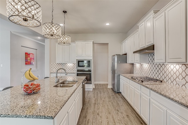 kitchen featuring stainless steel appliances, white cabinets, and tasteful backsplash