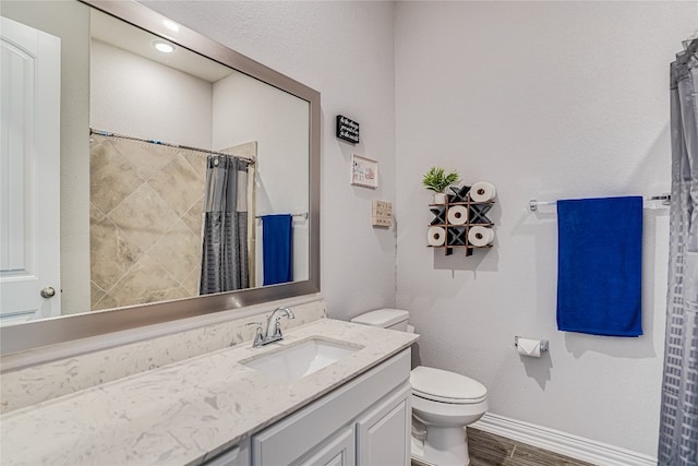 bathroom featuring vanity and toilet