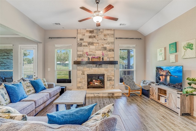 living room featuring ceiling fan, a fireplace, lofted ceiling, and hardwood / wood-style floors