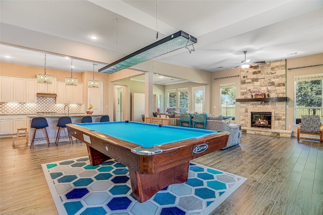 game room featuring ceiling fan, pool table, a healthy amount of sunlight, and a fireplace