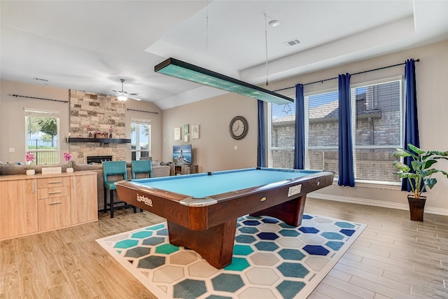 playroom featuring ceiling fan, light hardwood / wood-style floors, a stone fireplace, and billiards