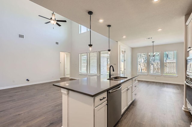 kitchen featuring dark wood-type flooring, visible vents, appliances with stainless steel finishes, and a sink