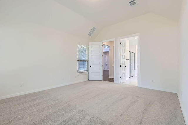 unfurnished bedroom featuring visible vents, carpet flooring, baseboards, and lofted ceiling