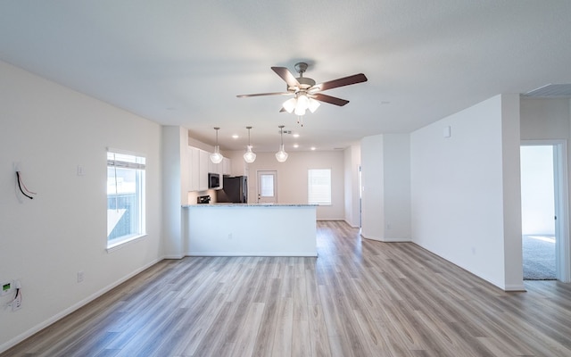 unfurnished living room with light hardwood / wood-style floors and ceiling fan