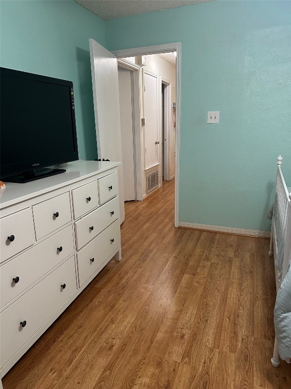 unfurnished bedroom with light wood-type flooring