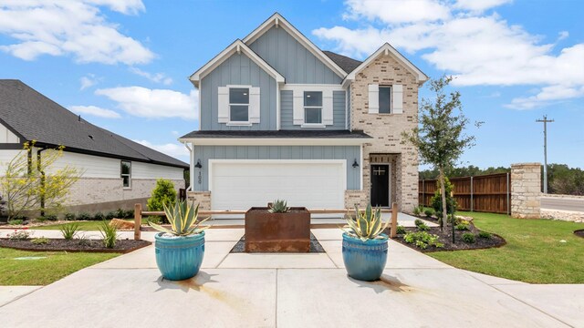 craftsman-style home featuring a front yard and a garage