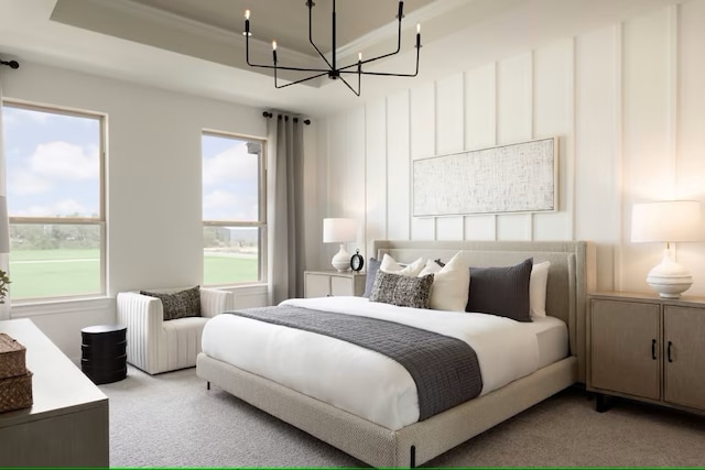 carpeted bedroom featuring a tray ceiling and an inviting chandelier