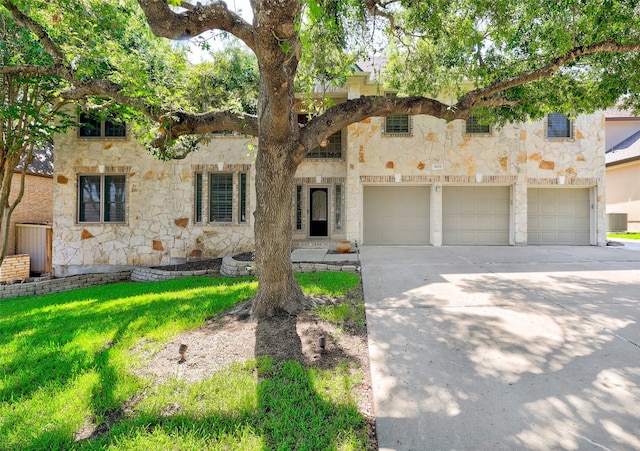 mediterranean / spanish-style house with a garage and a front yard