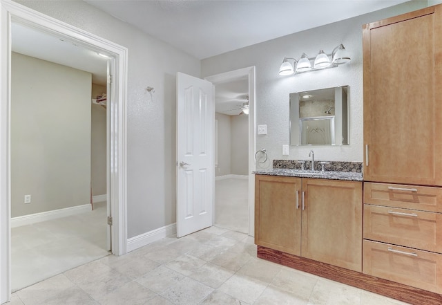 bathroom featuring ceiling fan, tile patterned flooring, and vanity