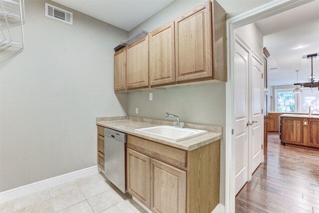 kitchen with sink, light wood-type flooring, and dishwasher