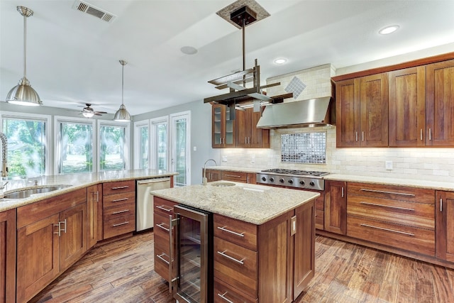 kitchen featuring hardwood / wood-style floors, sink, decorative light fixtures, wine cooler, and decorative backsplash