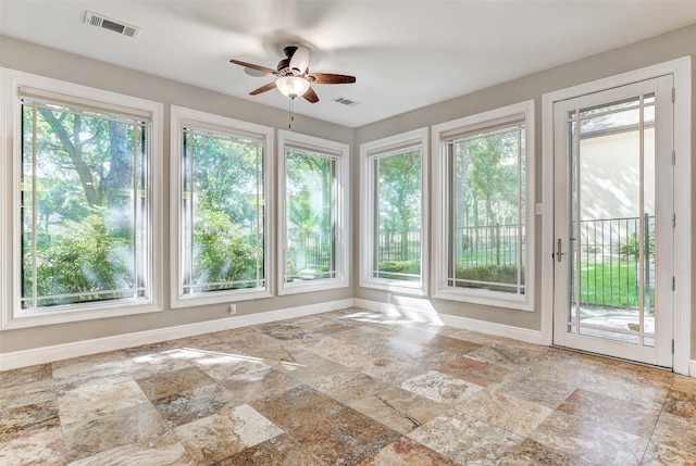 interior space with ceiling fan