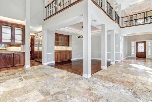 entrance foyer with a high ceiling, hardwood / wood-style flooring, and crown molding