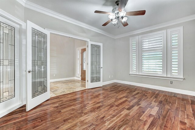 empty room with crown molding and wood-type flooring