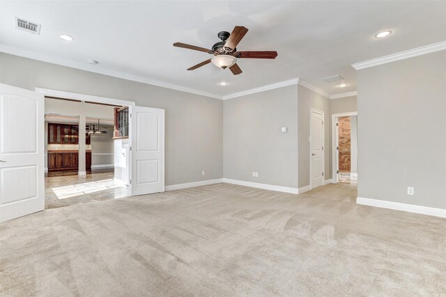 unfurnished room featuring ceiling fan, ornamental molding, and light colored carpet