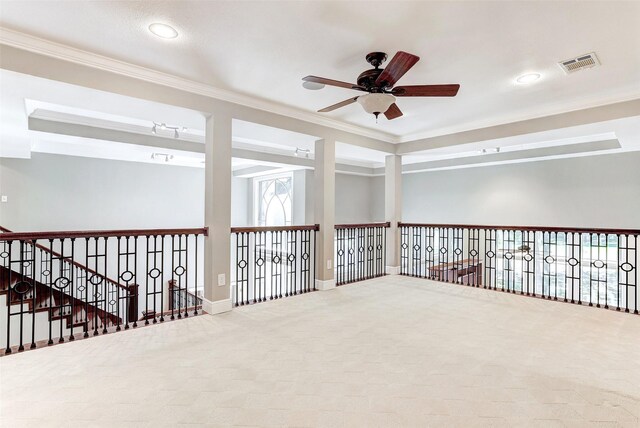 unfurnished room with ceiling fan, carpet, and crown molding