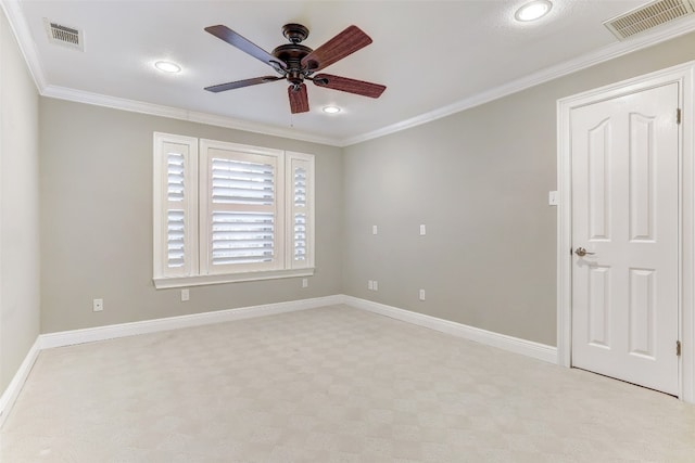 spare room featuring ceiling fan, ornamental molding, and light carpet