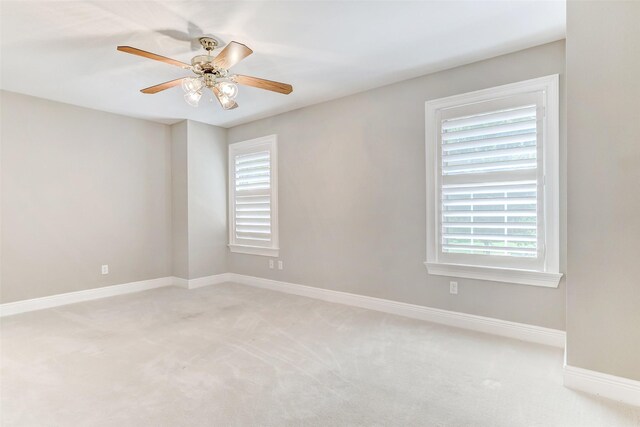 carpeted spare room with ceiling fan