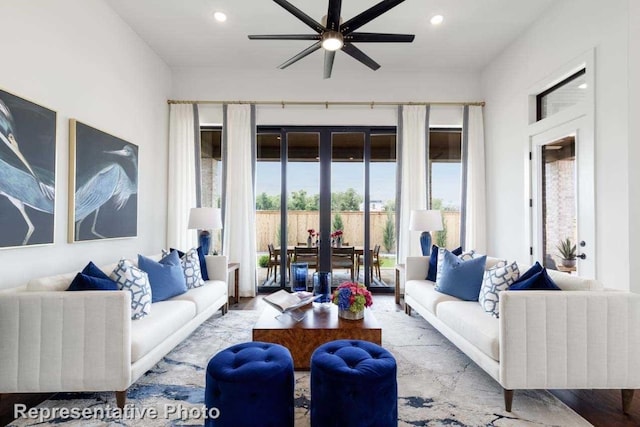 living room featuring ceiling fan and light hardwood / wood-style flooring