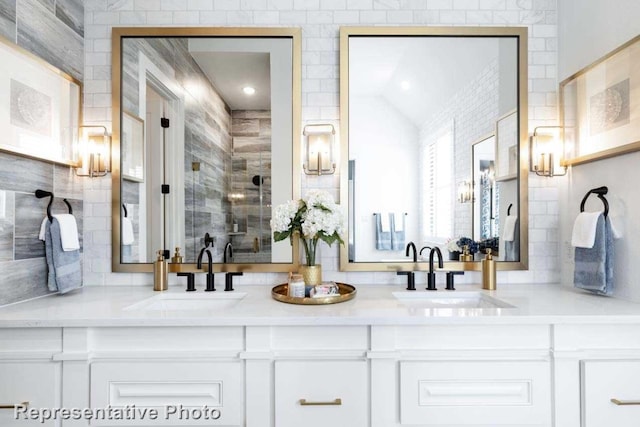 bathroom featuring tile walls, vaulted ceiling, and vanity