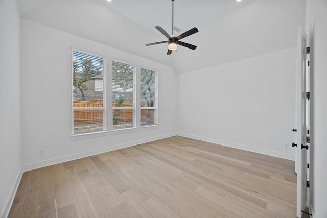 spare room featuring ceiling fan, lofted ceiling, and light hardwood / wood-style flooring