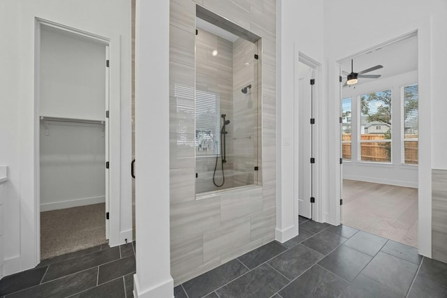 bathroom featuring tiled shower, tile patterned floors, and ceiling fan