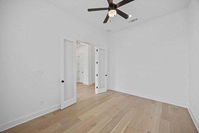 spare room with ceiling fan and light wood-type flooring