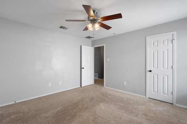 unfurnished bedroom with ceiling fan and light colored carpet