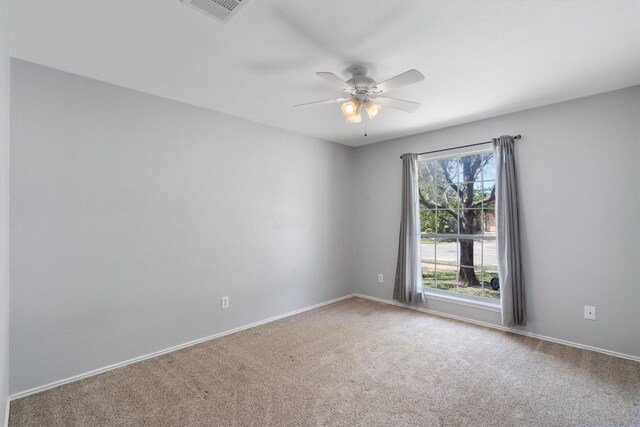 spare room with carpet flooring and ceiling fan