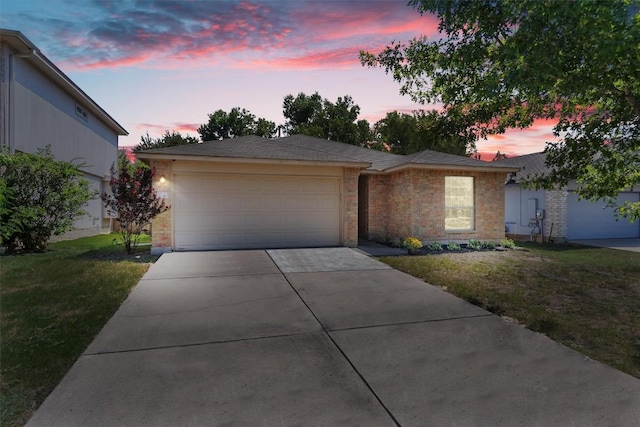 view of front of property featuring concrete driveway, brick siding, a lawn, and an attached garage