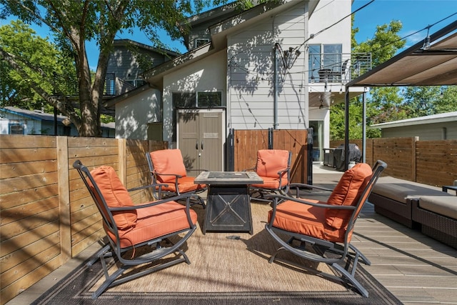 wooden deck featuring grilling area and an outdoor fire pit