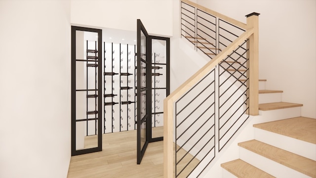 stairs featuring hardwood / wood-style floors