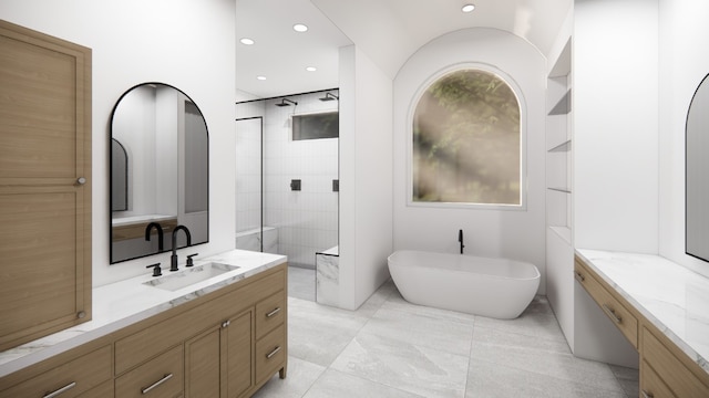 bathroom featuring tile patterned flooring, a bathing tub, and vanity