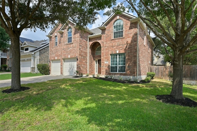 view of property featuring a garage and a front yard